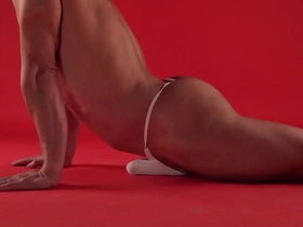 Daring woman practices yoga in her red thong, causing a stir