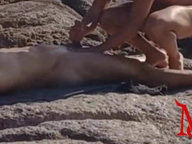 Gay amateurs get a rubdown on the rocky beach
