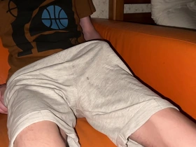 A slender boy pours his shorts with his massive load